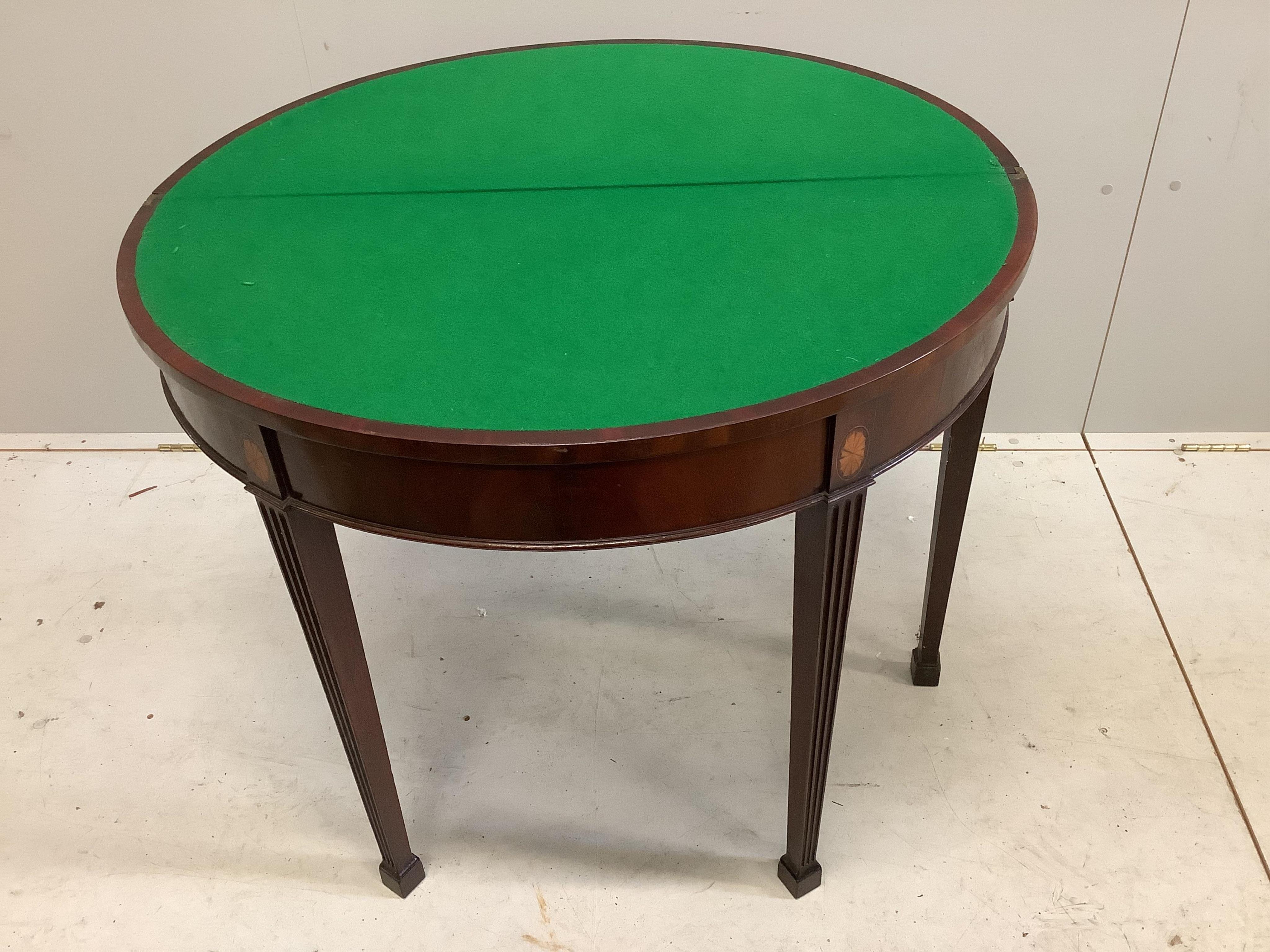 An Edwardian inlaid mahogany demi lune card table, width 91cm, height 73cm. Condition - top scratched, otherwise fair